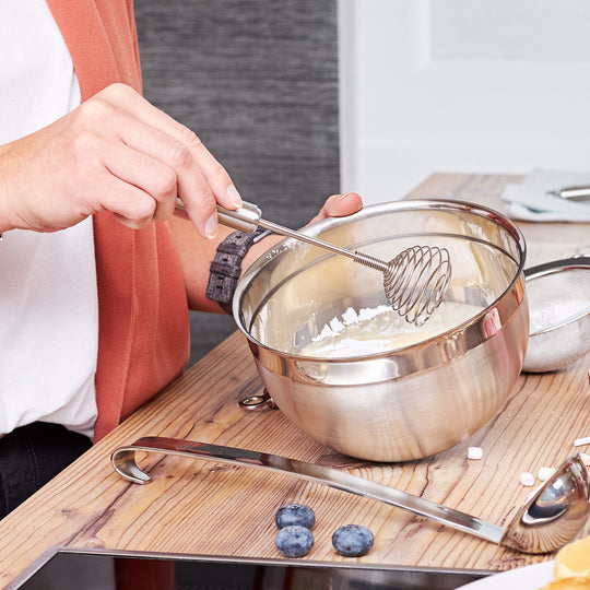 a person mixing ingredients in a bowl